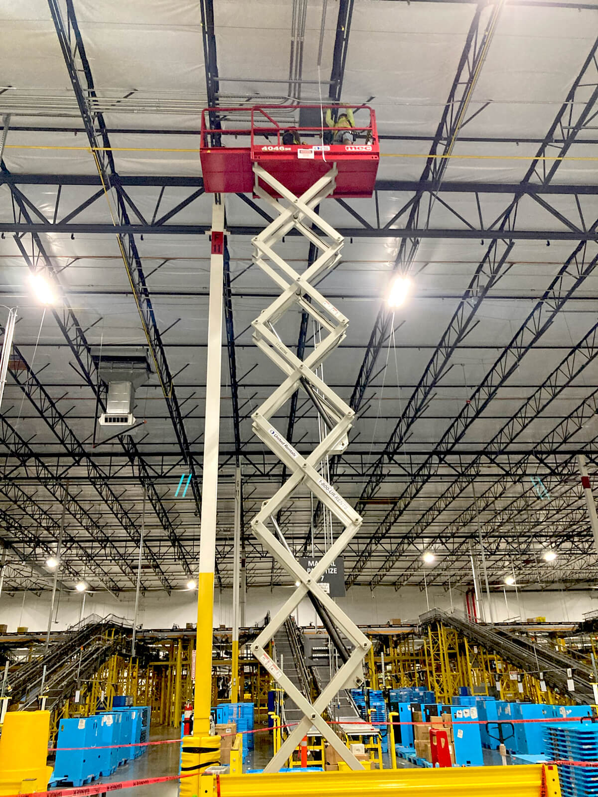 mechanical electrical trade team on scissor lift