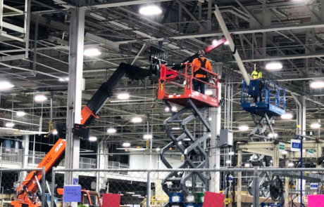 team members installing overhead structural steel
