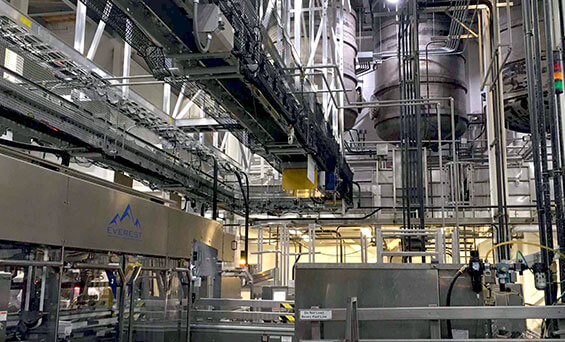 material handling conveyor system for bottling and packing system