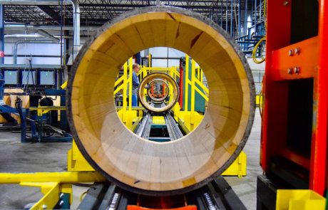 unfinished bourbon barrel on conveyor system
