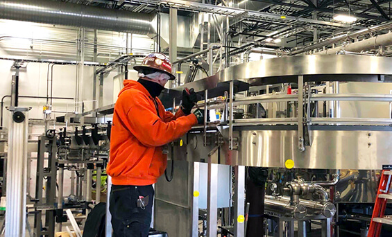 worker installing conveyor equipment