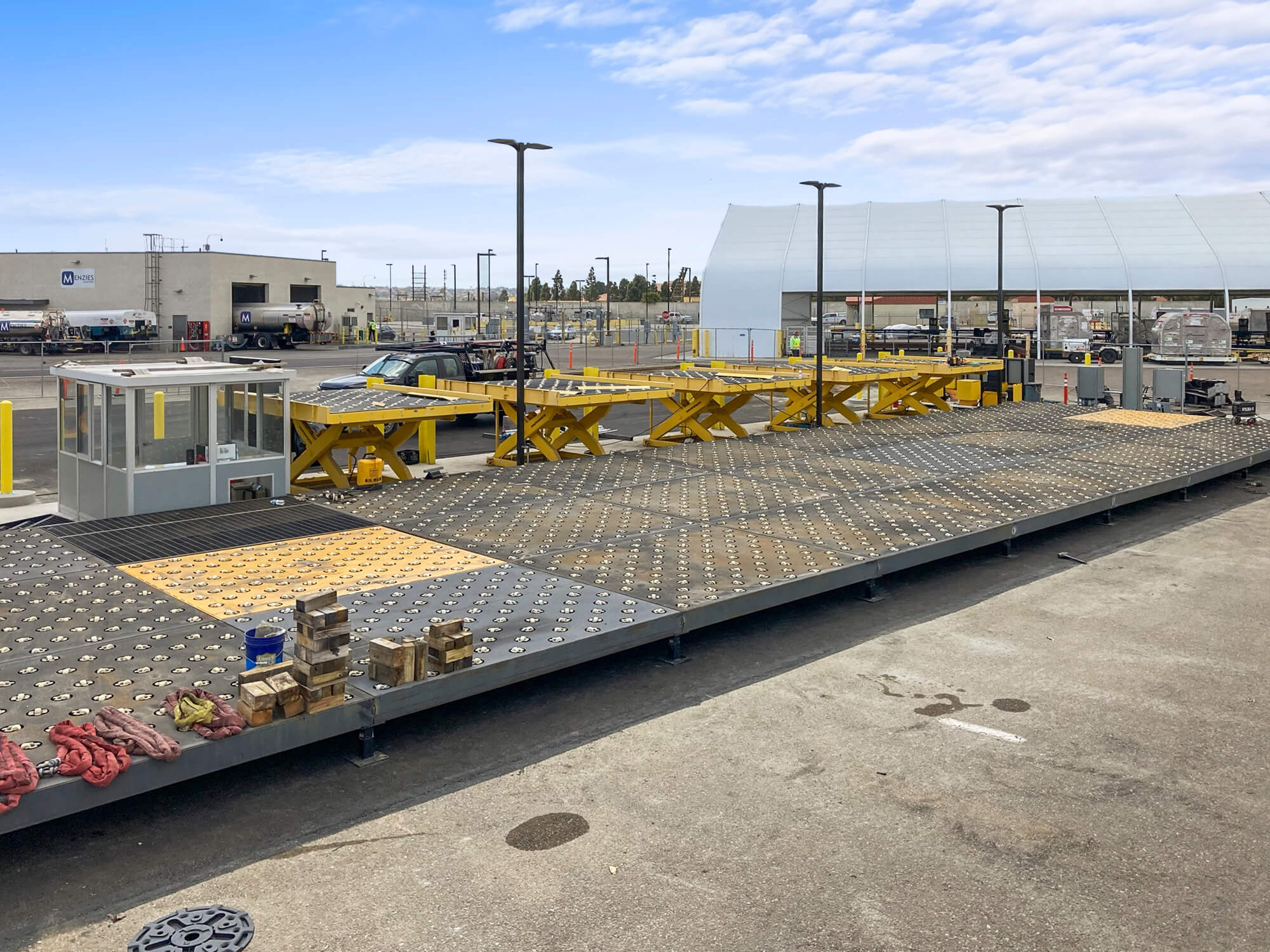 millwrights installing caster deck and lifts for truck deck at air cargo terminal