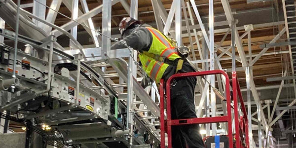 millwright during mechanical installation of overhead conveyor system