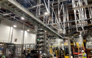 overhead conveyor installation for beverage facility
