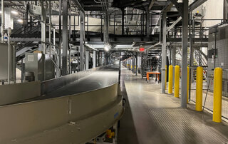 walkway, conveyor and bollards near a conveyor system in parcel handling facility