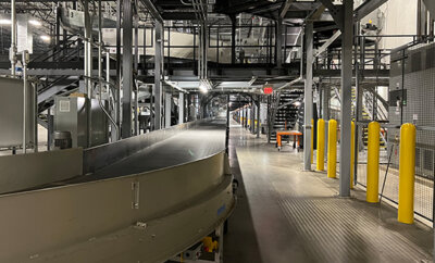 walkway, conveyor and bollards near a conveyor system in parcel handling facility