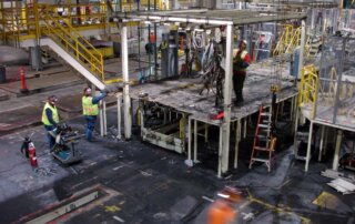 industrial mechanics dismantling robotic cell in auto manufacturing system