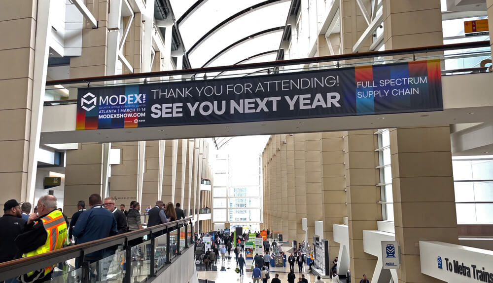 overhead signage at promat 2023promoting modex 2024