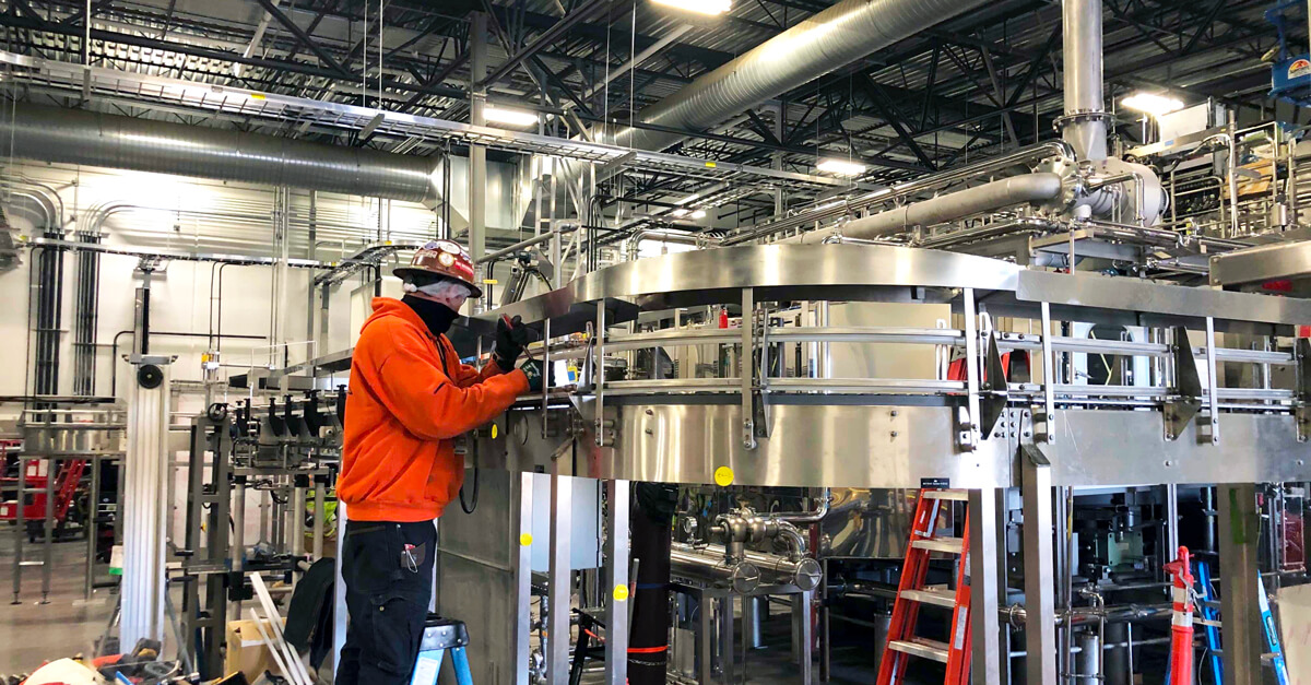 worker installing conveyor equipment