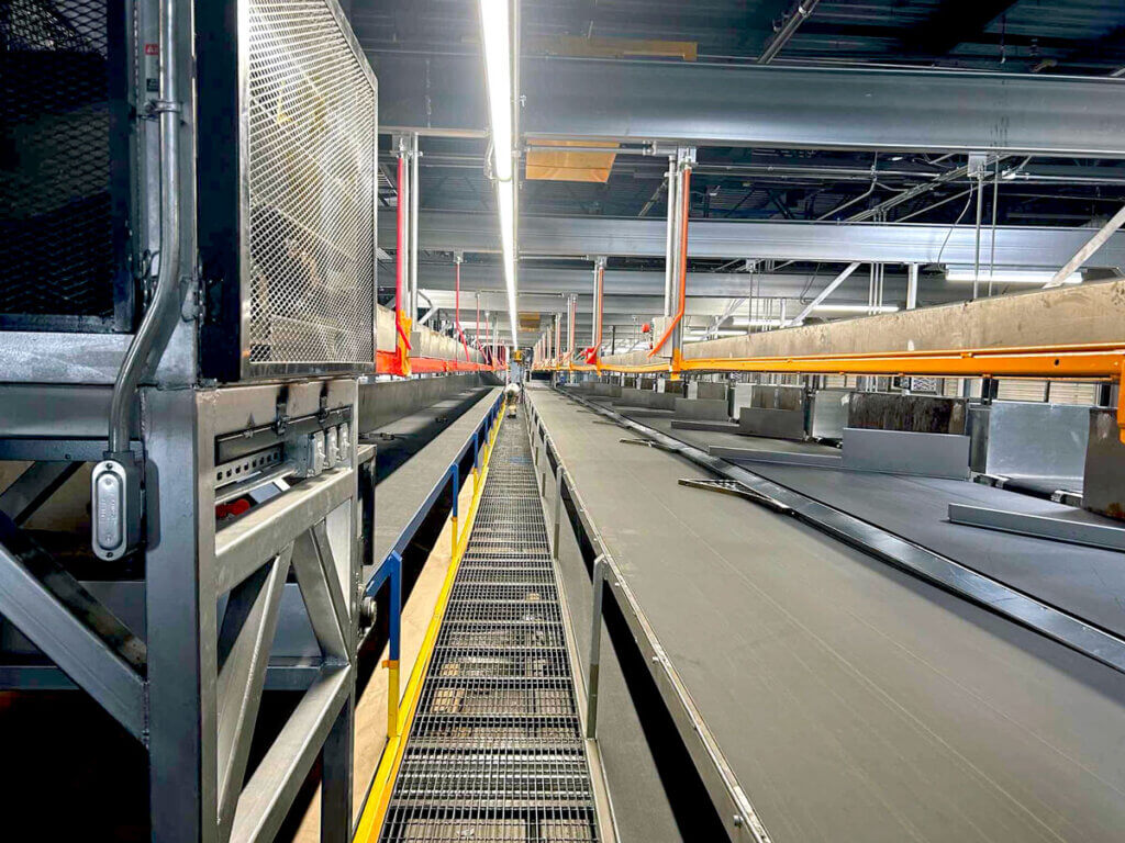 View down a newly installed conveyor system line inside a SilMan Industries project.