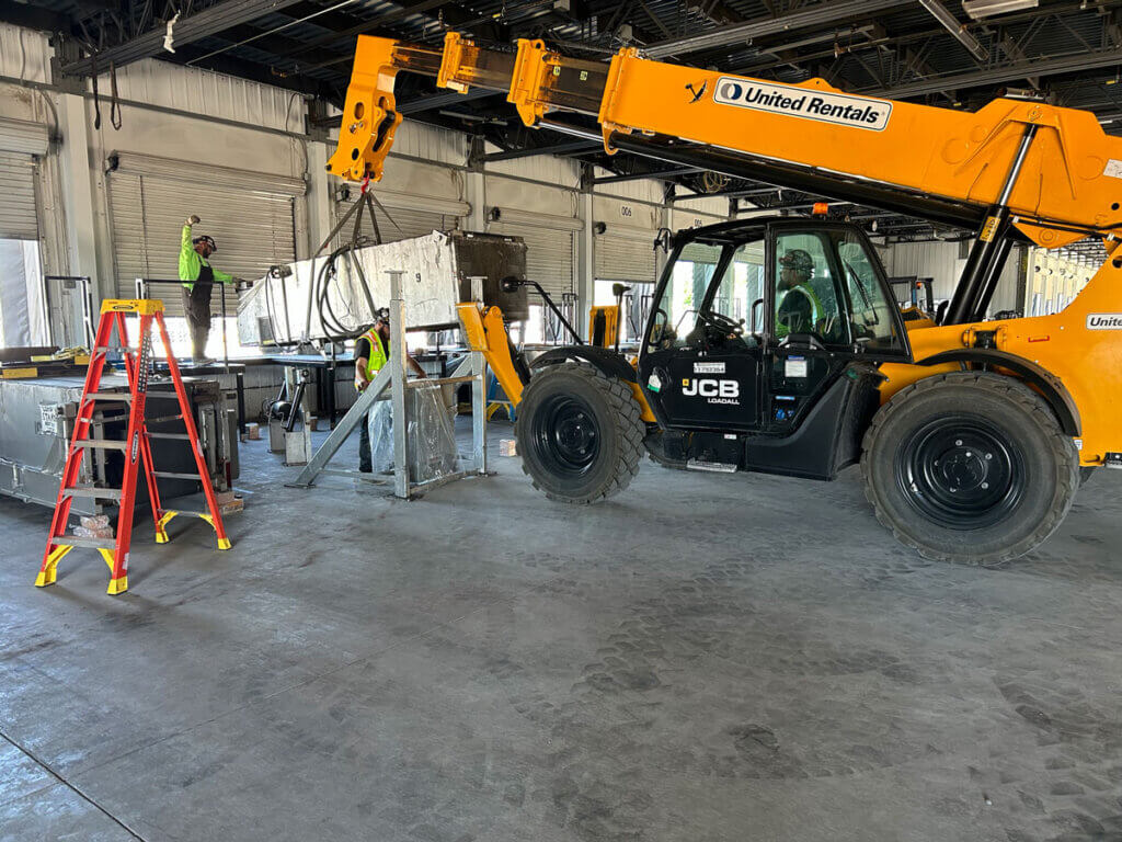 SilMan millwrights performing MHE installation of conveyor systems inside the new parcel hub.